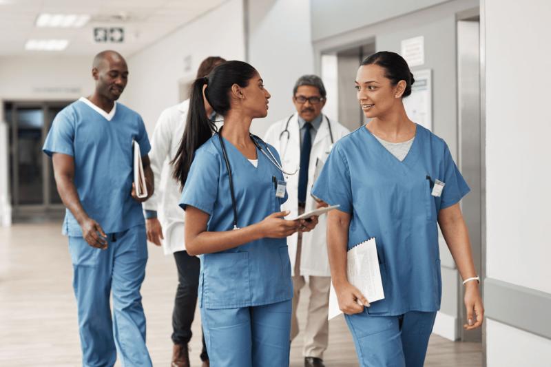 Group of nurses walking together in a hospital hallway